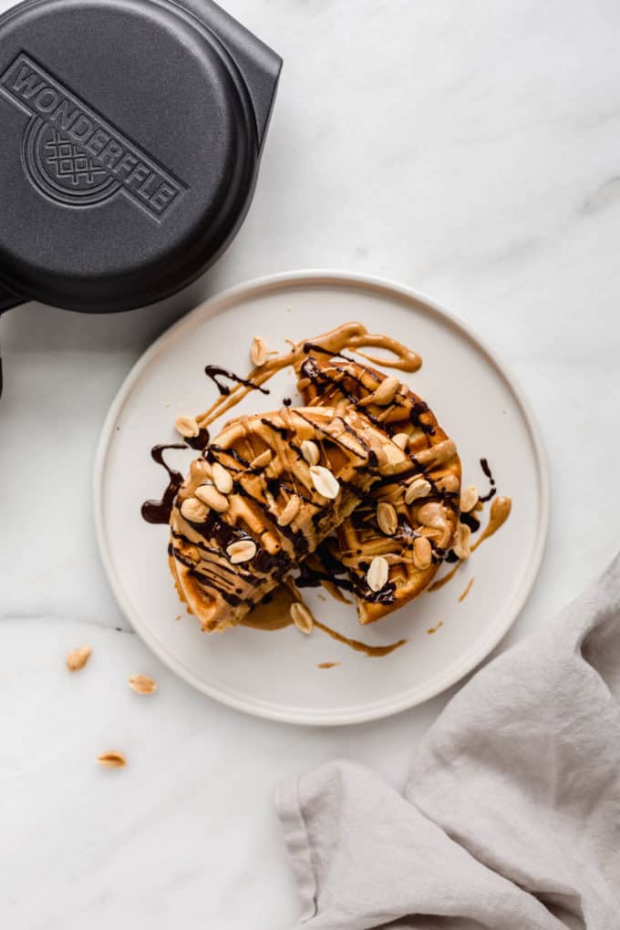 a snickers waffle on a plate with a napkin on the side