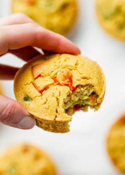 a hand holding a chickpea mini quiche