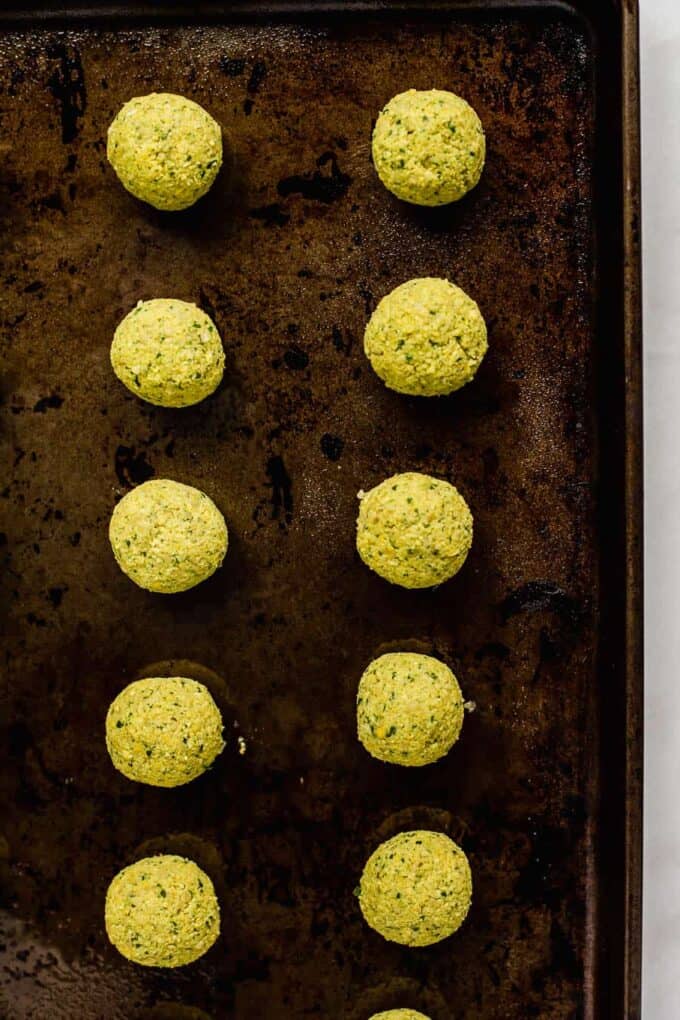 unbaked falafel on a baking sheet