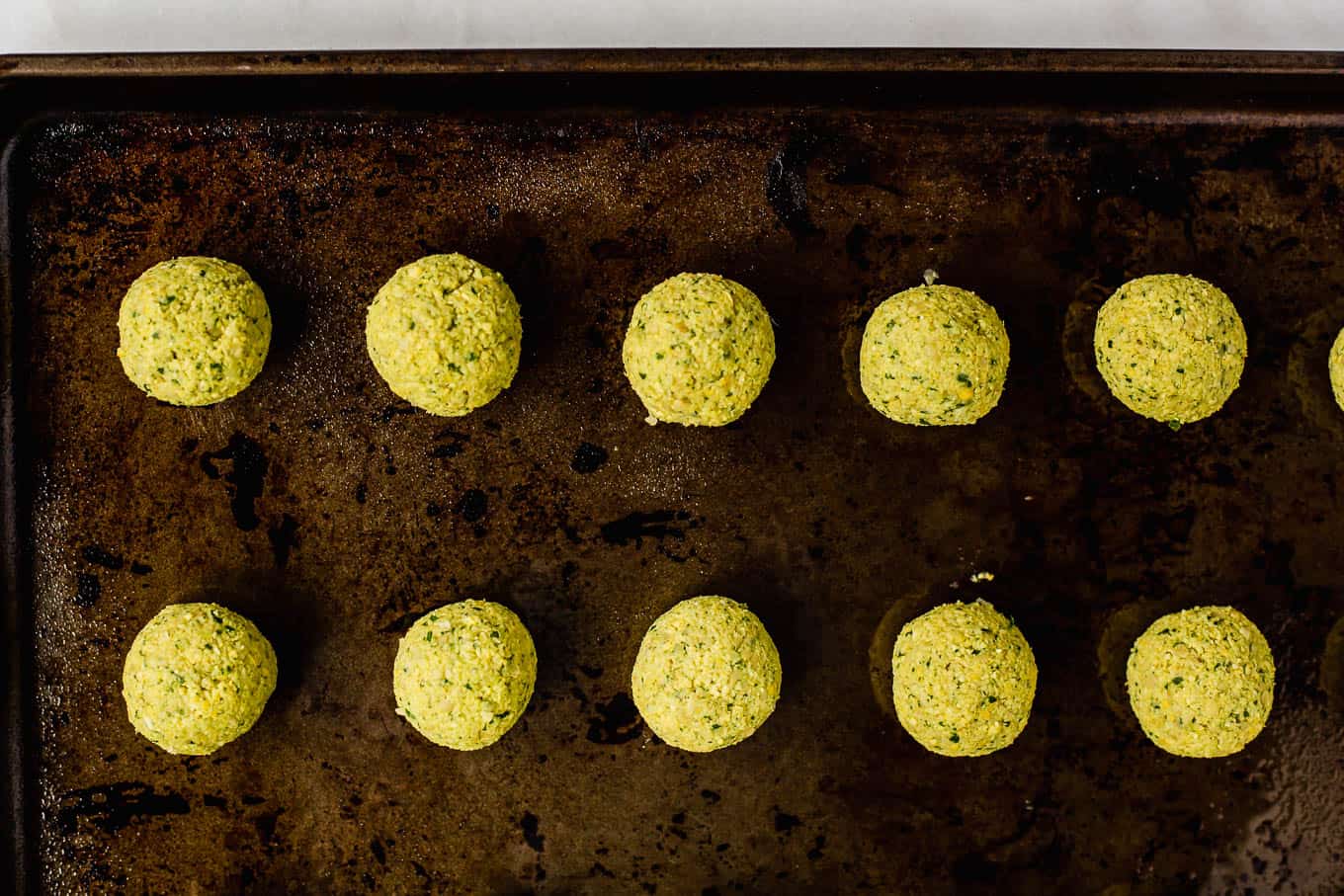 unbaked falafel on a baking sheet