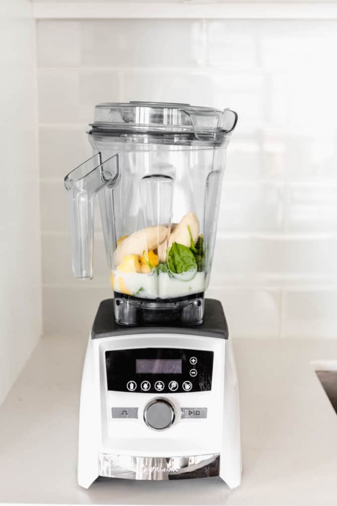 fruits, spinach and almond milk in a blender