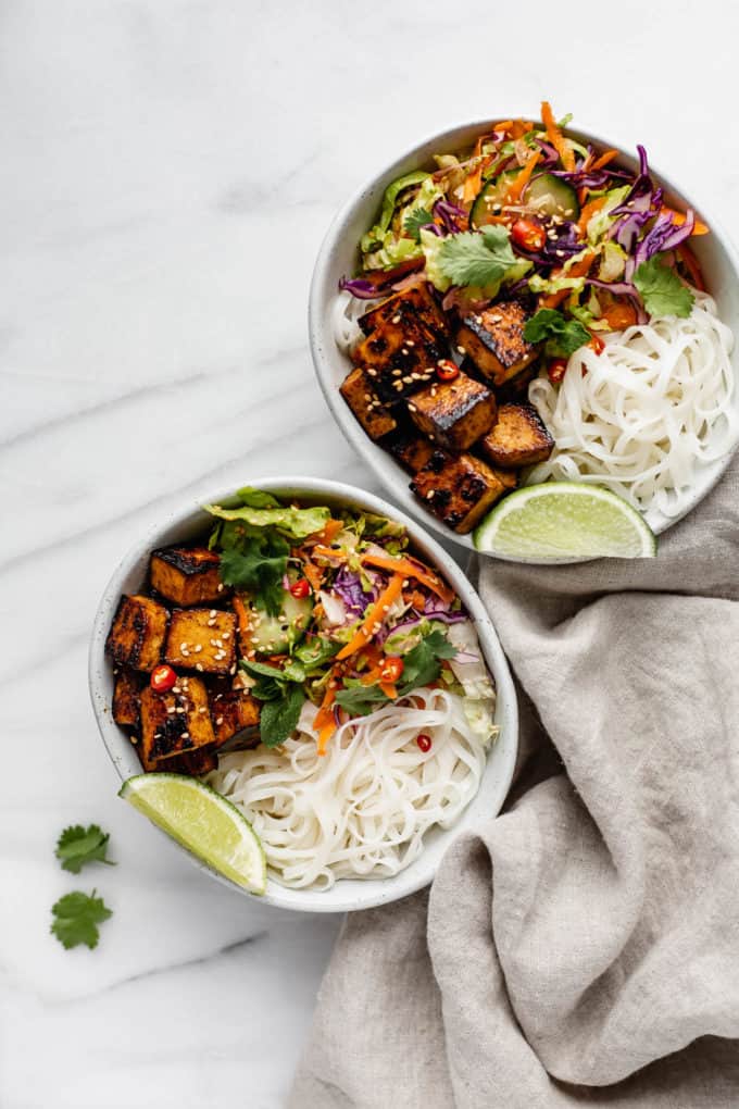 Two Vietnamese noodle bowls on a marble counter