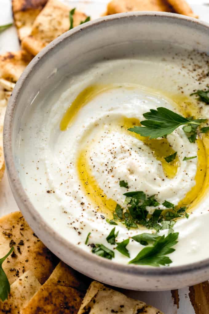 Whipped feta dip in a beige ceramic bowl