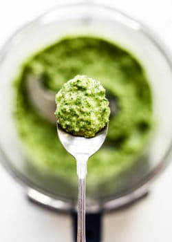 A spoon with walnut pesto on it