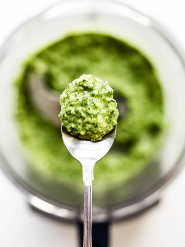 A spoon with walnut pesto on it