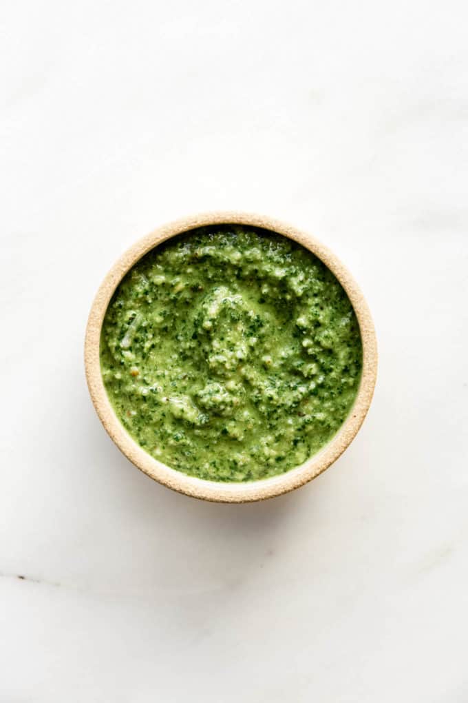 walnut pesto in a beige ceramic bowl