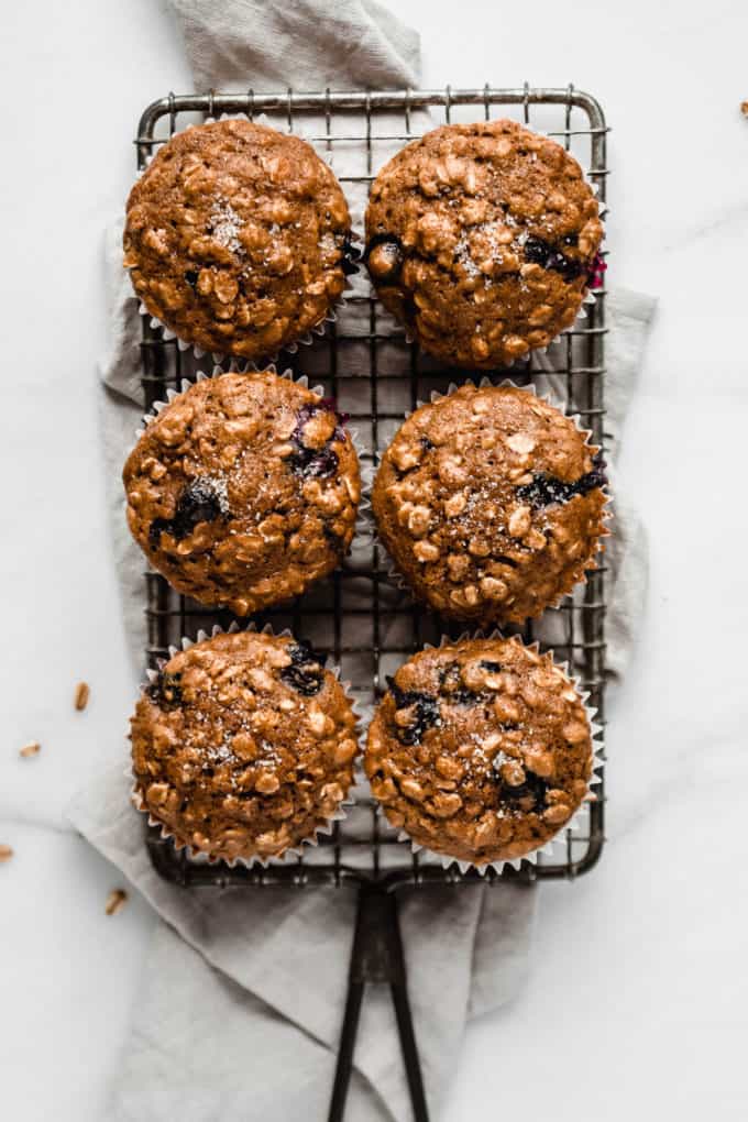 6 blueberry muffins on a cooling rack