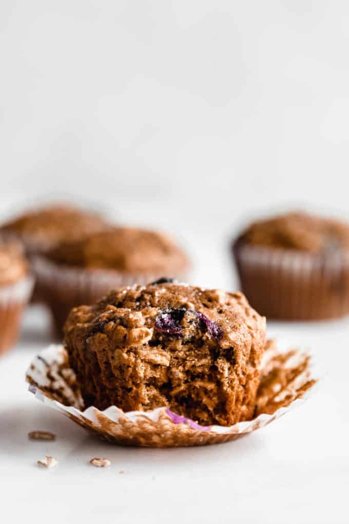 A blueberry muffin with a bite taken out of it
