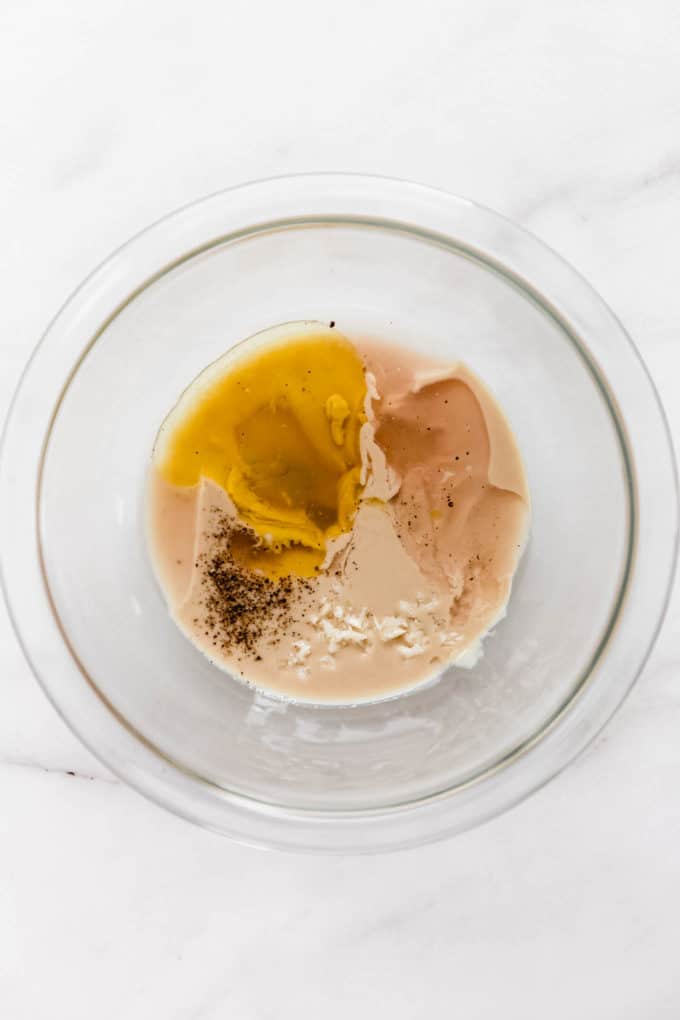 tahini, olive oil, garlic, salt and pepper in a mixing bowl