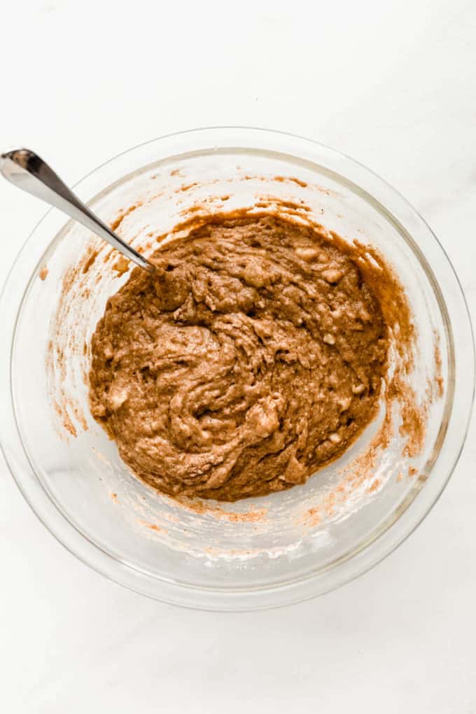 Banana nut muffin batter in a clear mixing bowl
