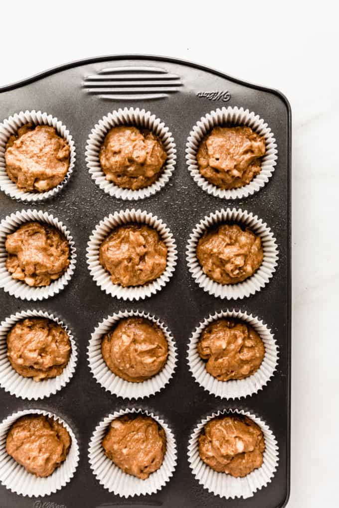 Banana nut muffin batter in a muffin pan