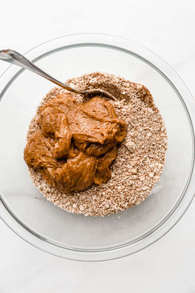 Almond butter and almond flour mixture in a clear mixing bowl