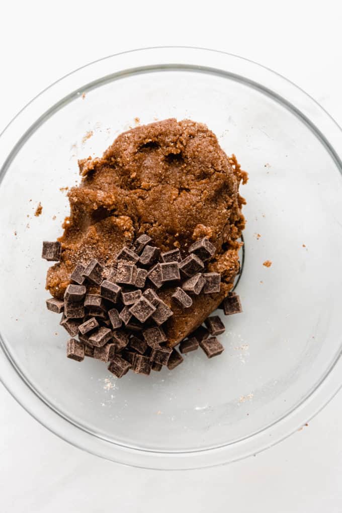 Almond butter blondie batter and chocolate chunks in a bowl