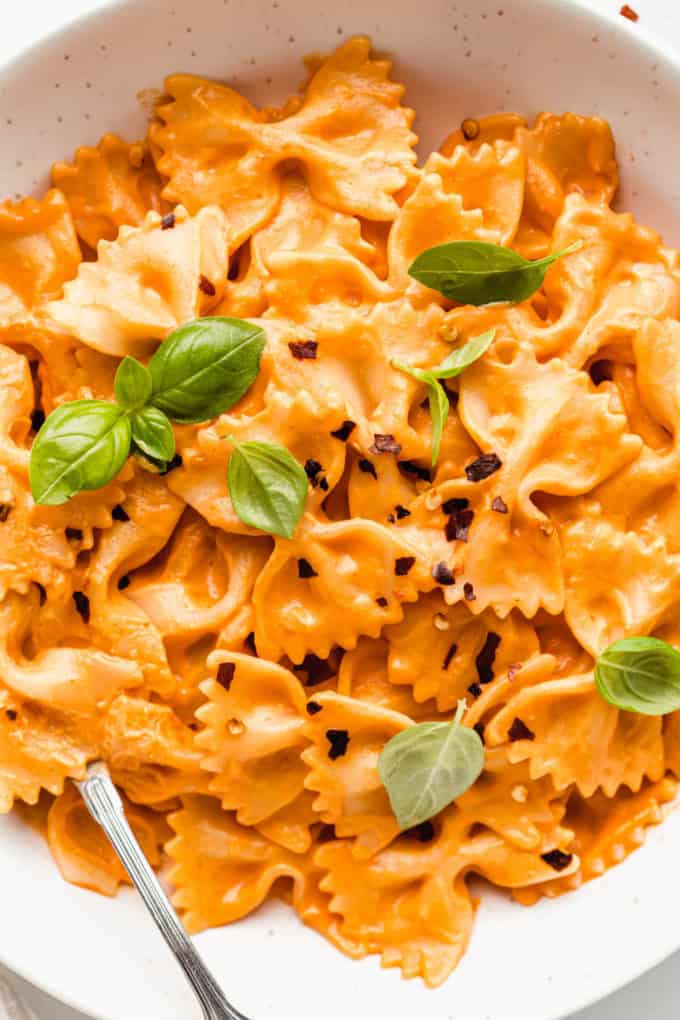 A bowl of farfalle pasta with vegan vodka sauce on it