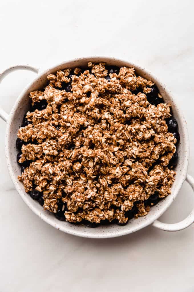 Unbaked blueberry crisp in a baking dish