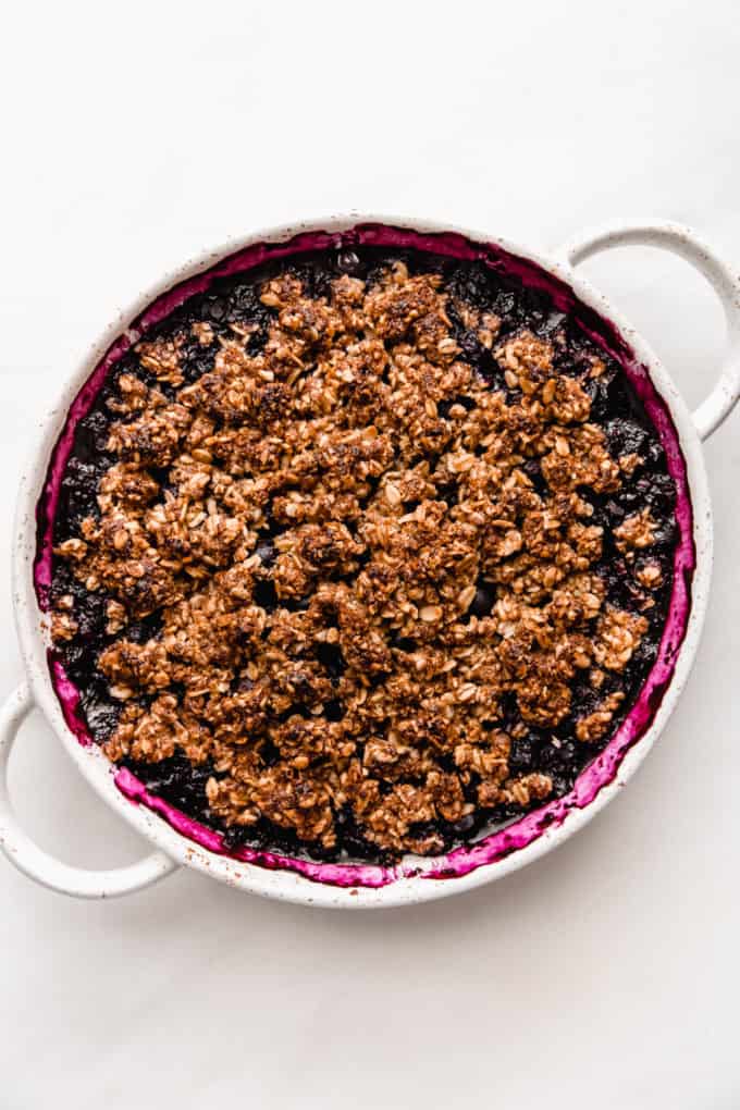 Blueberry crisp in a white baking dish