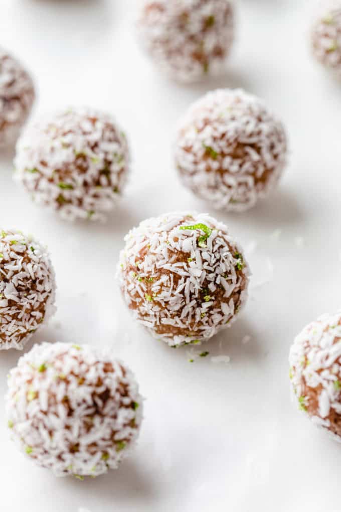 a key lime pie energy ball with shredded coconut and lime zest on it