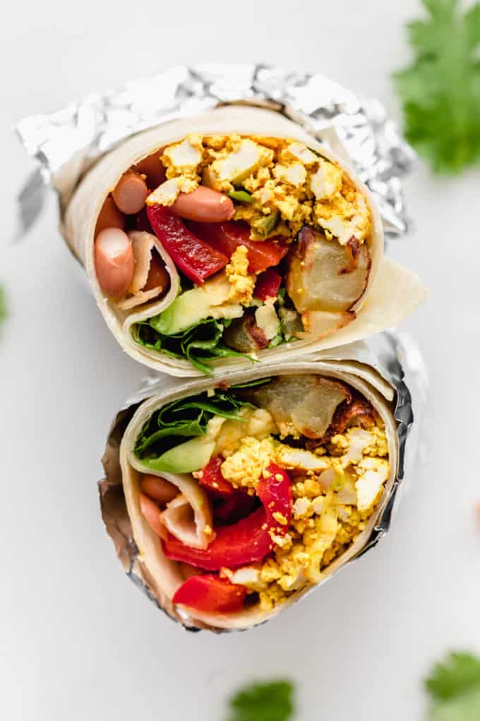 A vegan breakfast burrito wrapped in aluminum foil