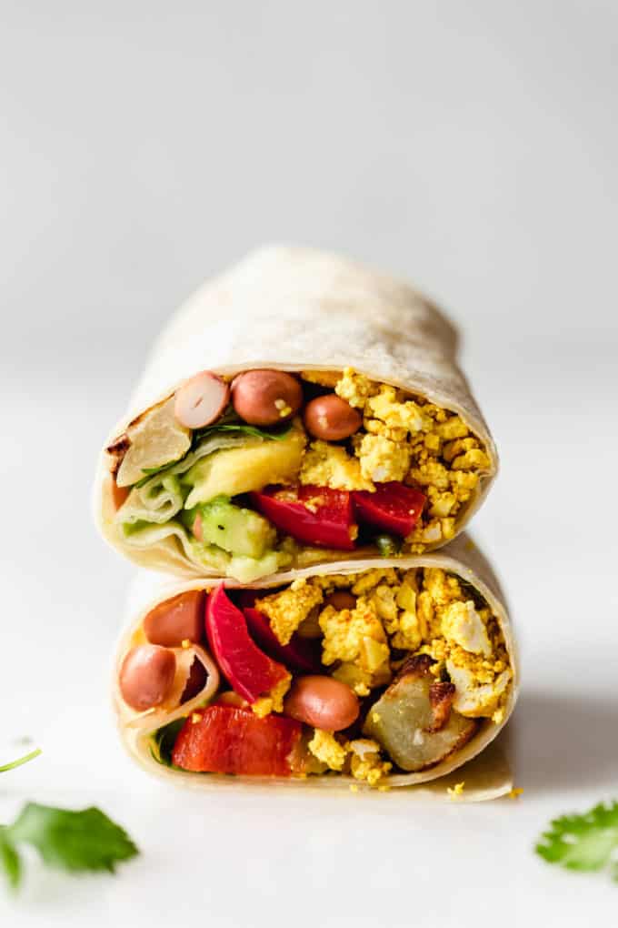 A vegan breakfast burrito stacked on top of each other