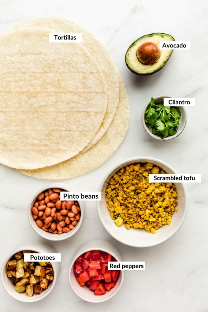 A flat lay of ingredients for vegan breakfast burritos