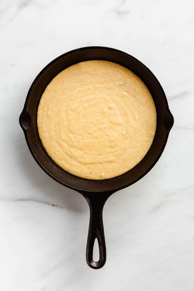 vegan cornbread batter in cast iron skillet