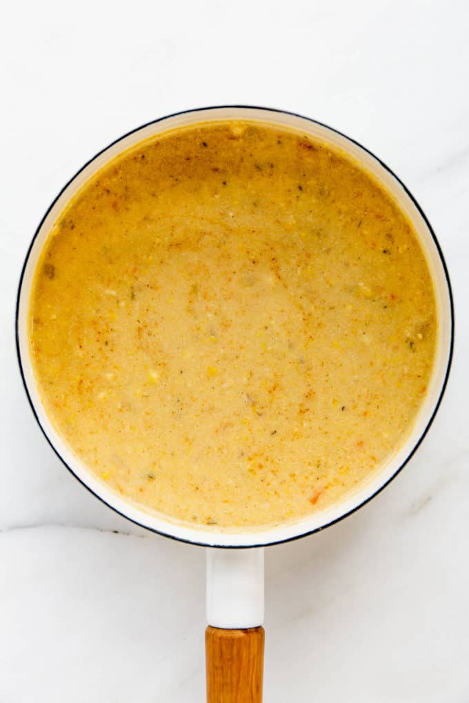 A white pot with vegan corn chowder in it