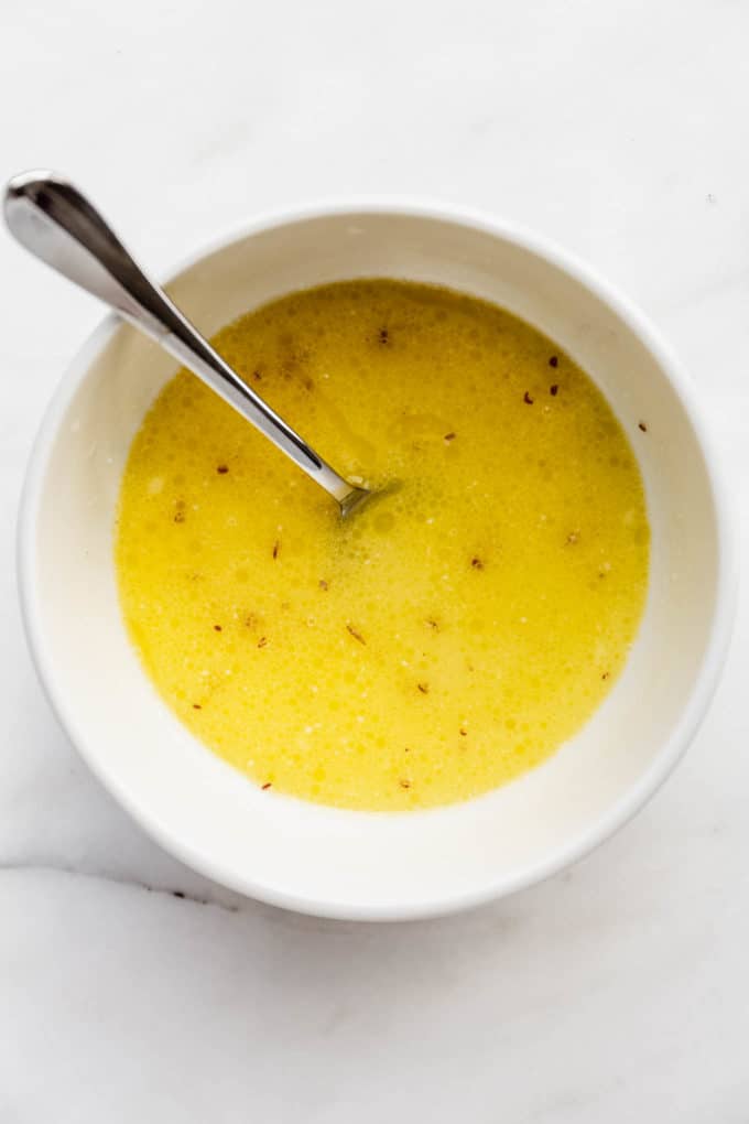 Melted vegan butter, flax seeds and oat milk in a bowl