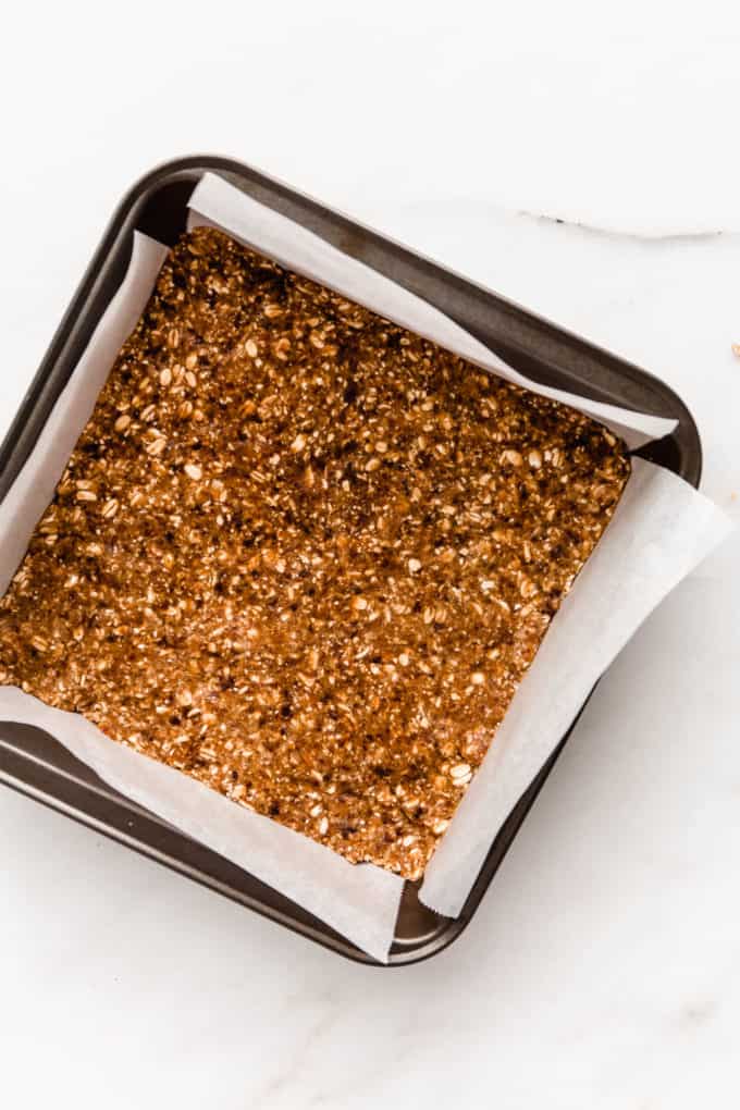 An 8x8 inch baking dish with vegan cheesecake crust in it