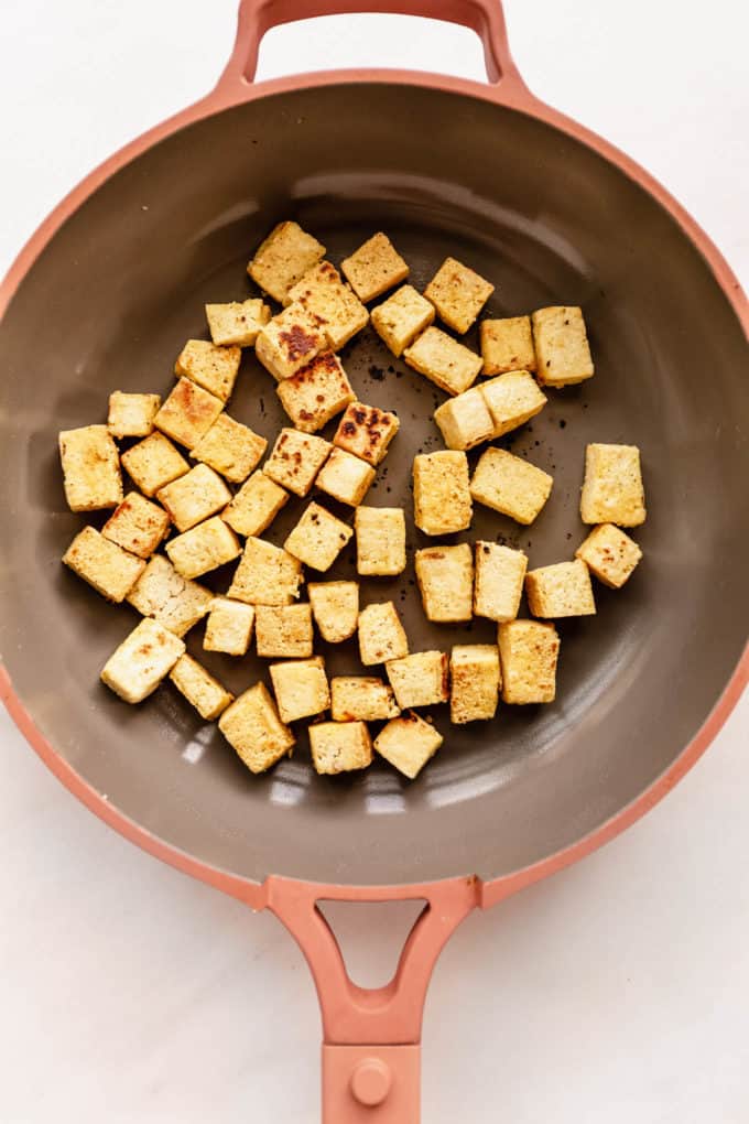 crispy tofu cubes in a pan