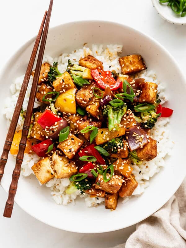 a bowl of tofu stir fry with veggies served over rice