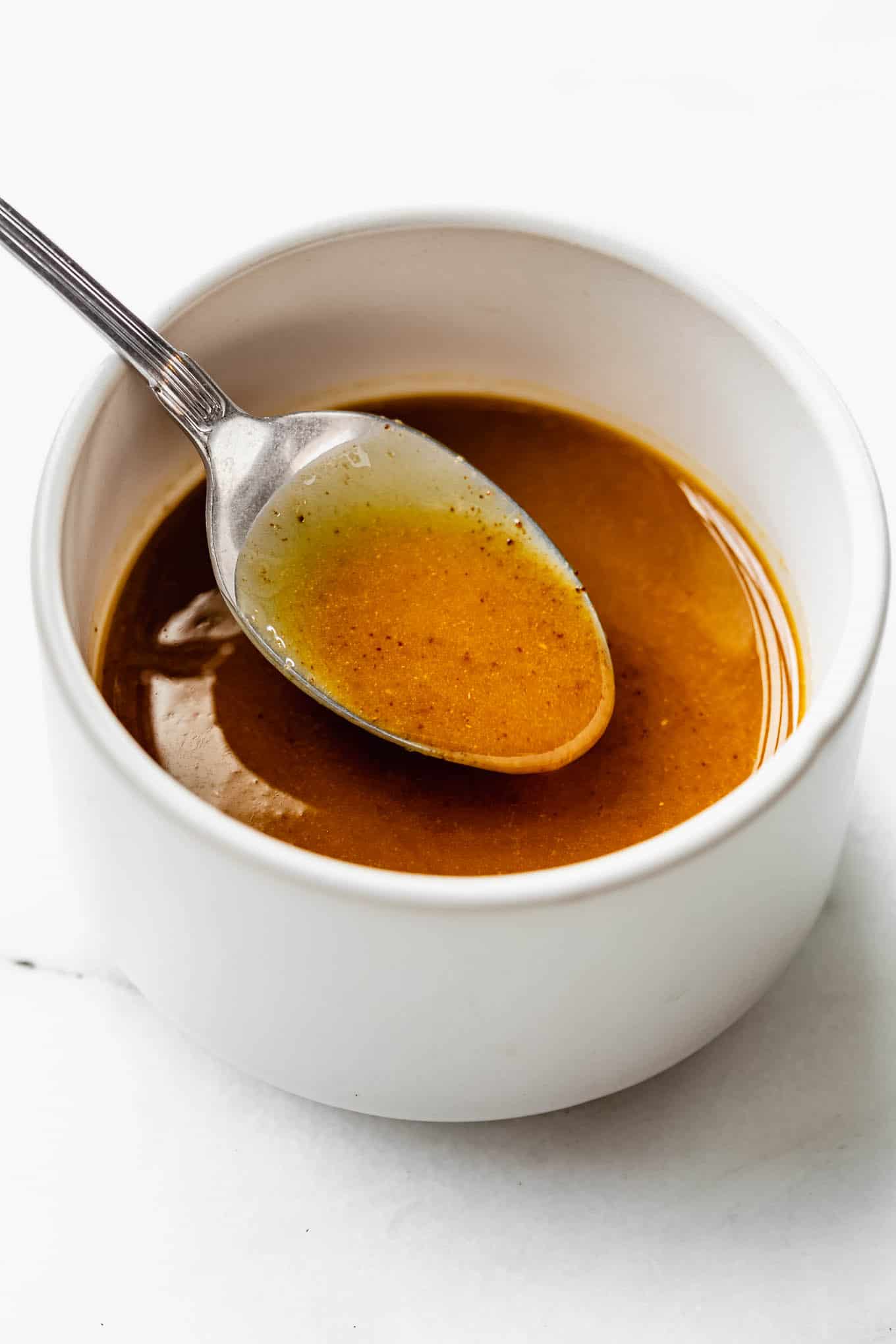 a white small bowl with chilli lime dressing in it