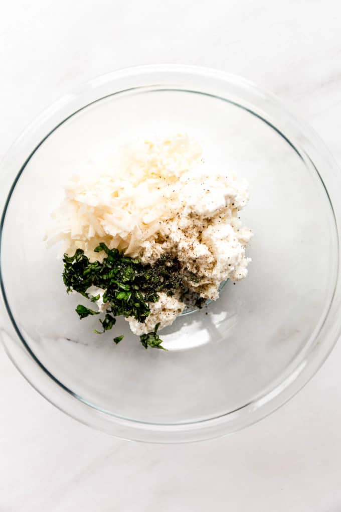 Ricotta, Parmesan and herbs in a mixing bowl