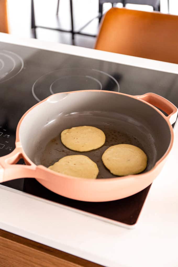 pancakes being cooked in a pan