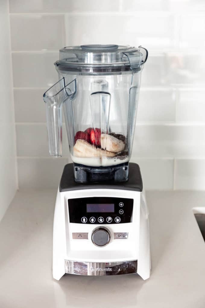 bananas, strawberries, almond milk and chia seeds in a vitamix blender