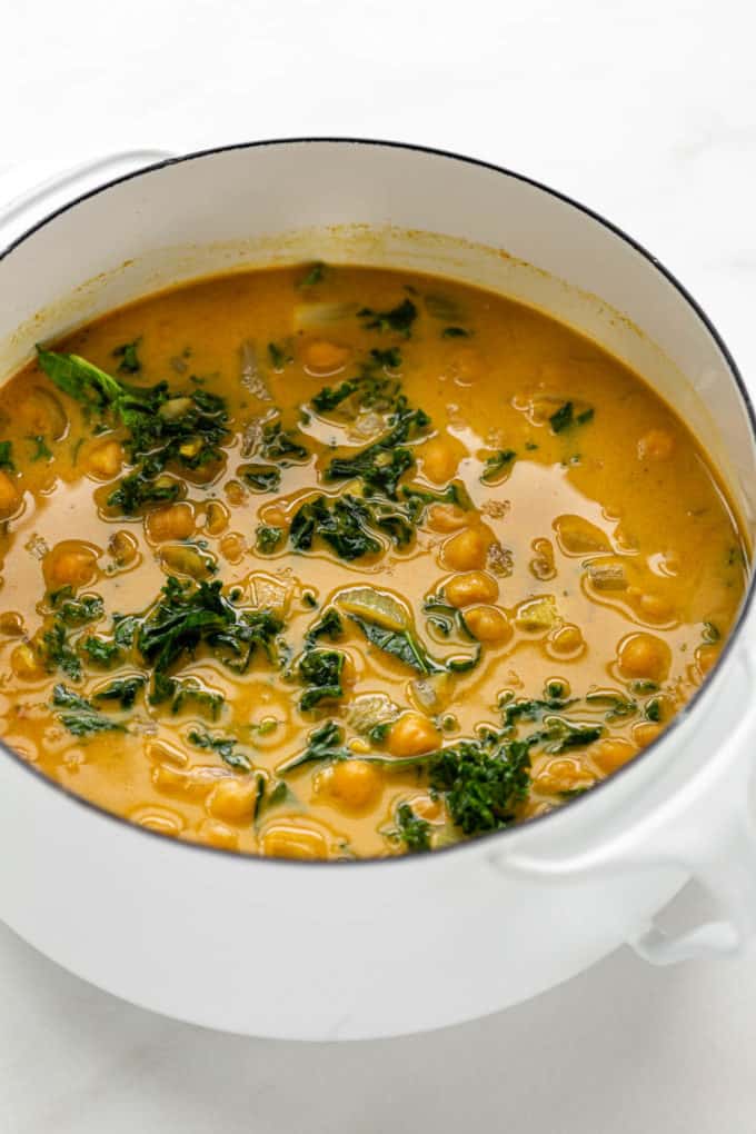 A pot with coconut curry chickpeas in it