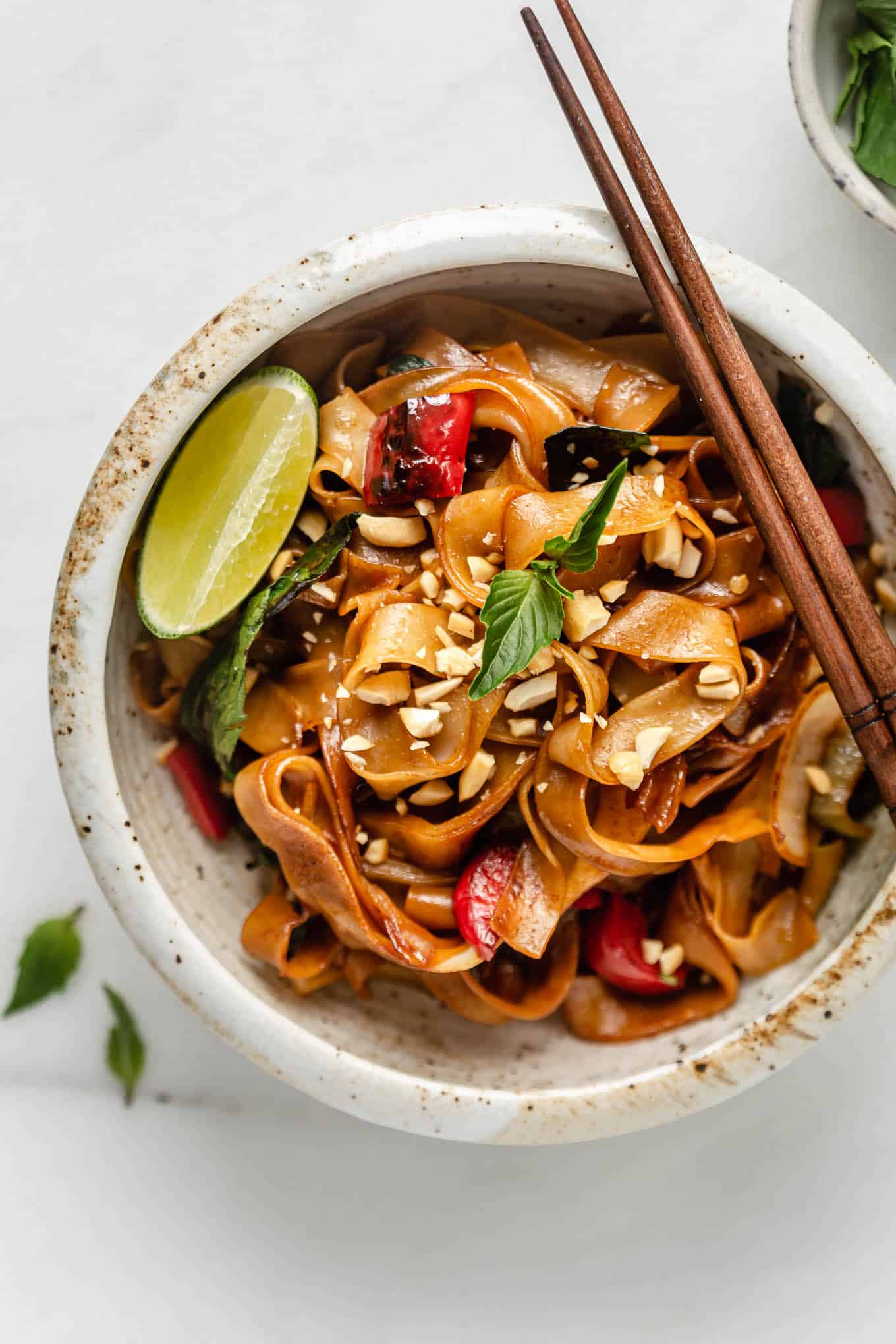 A bowl of Thai drunken noodles with chopsticks