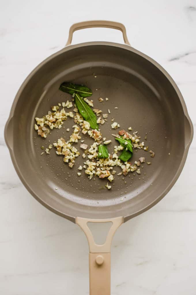 sage, garlic and shallots in a pan