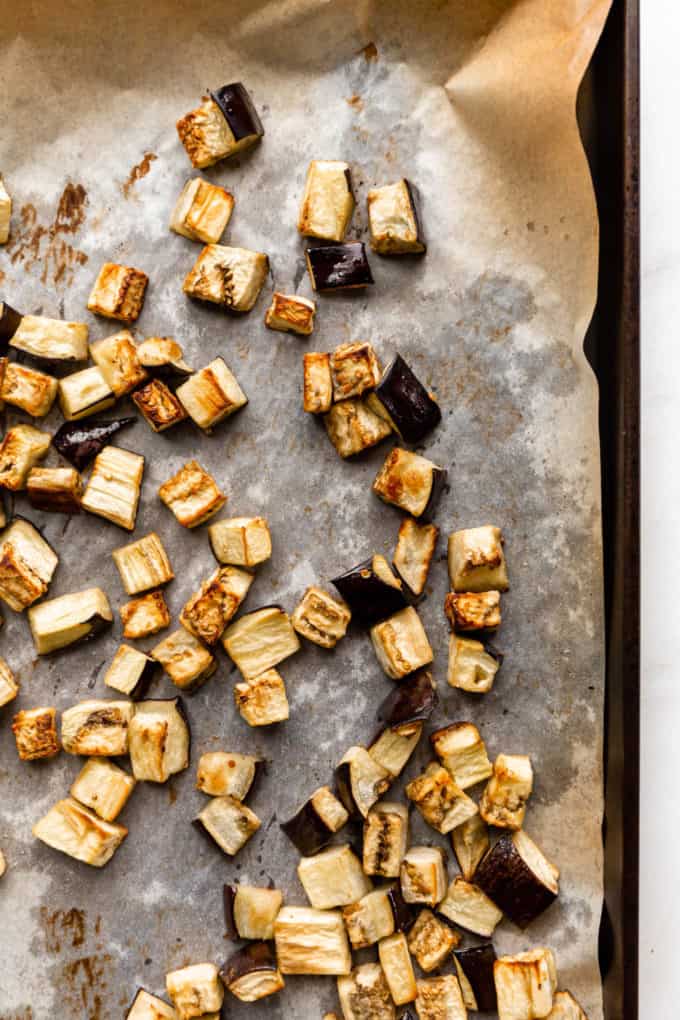 Roasted cubed eggplant on a baking sheet