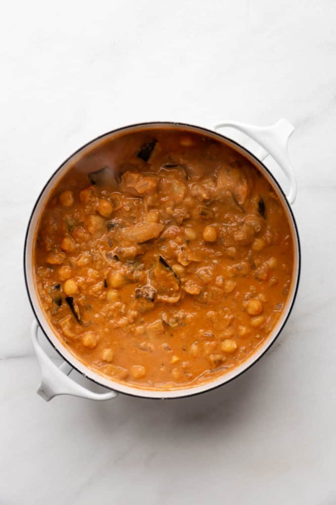 A white pot of eggplant curry