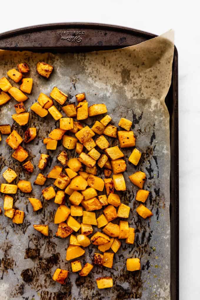 roasted pumpkin cut into cubes on a baking sheet