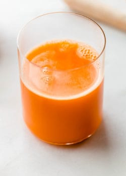 A glass of orange carrot and ginger juice