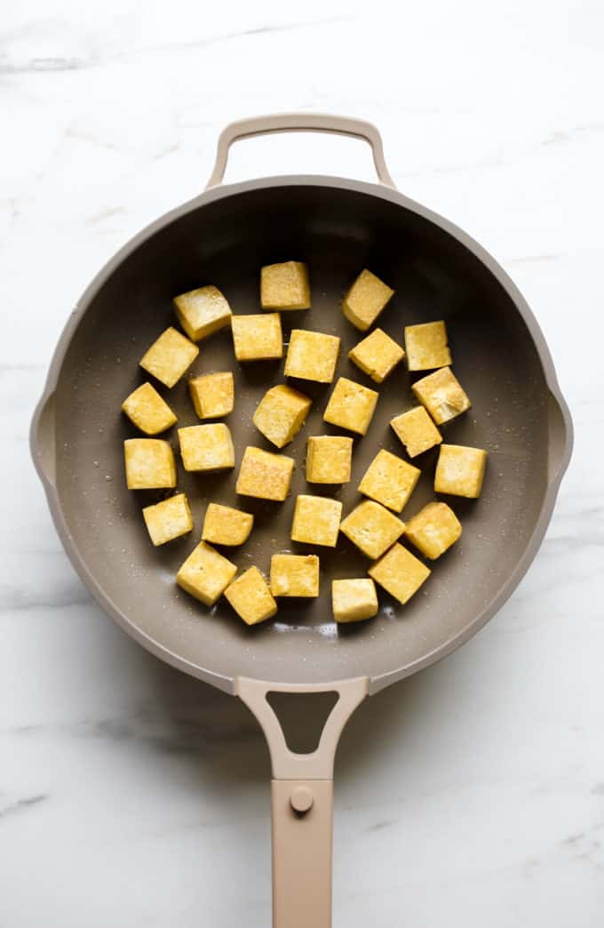 cubes of tofu in a frying pan