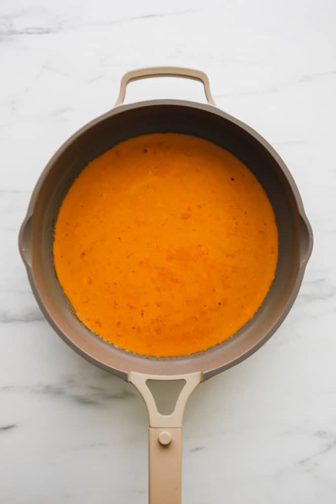 a pan with coconut red curry sauce in it