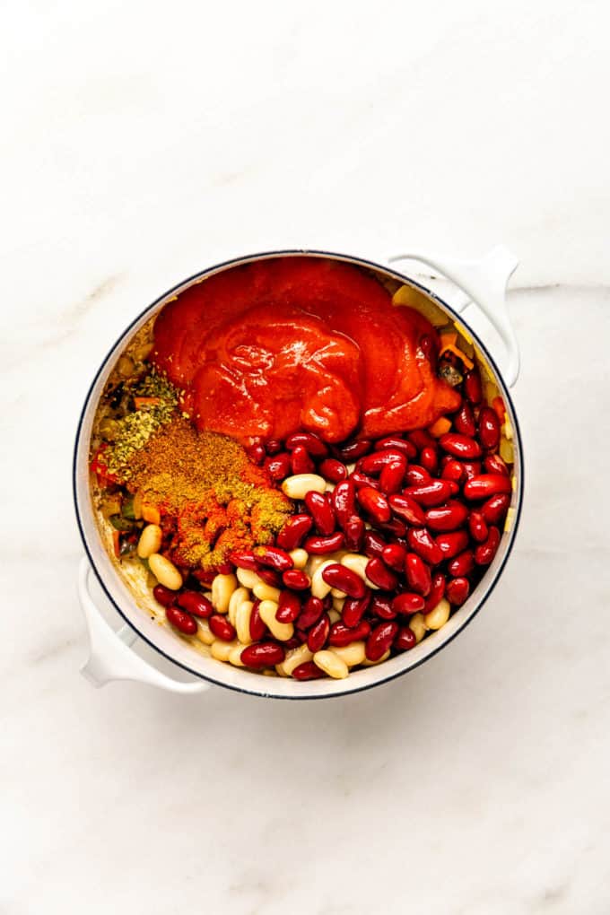 beans, tomatoes and spices in a white pot