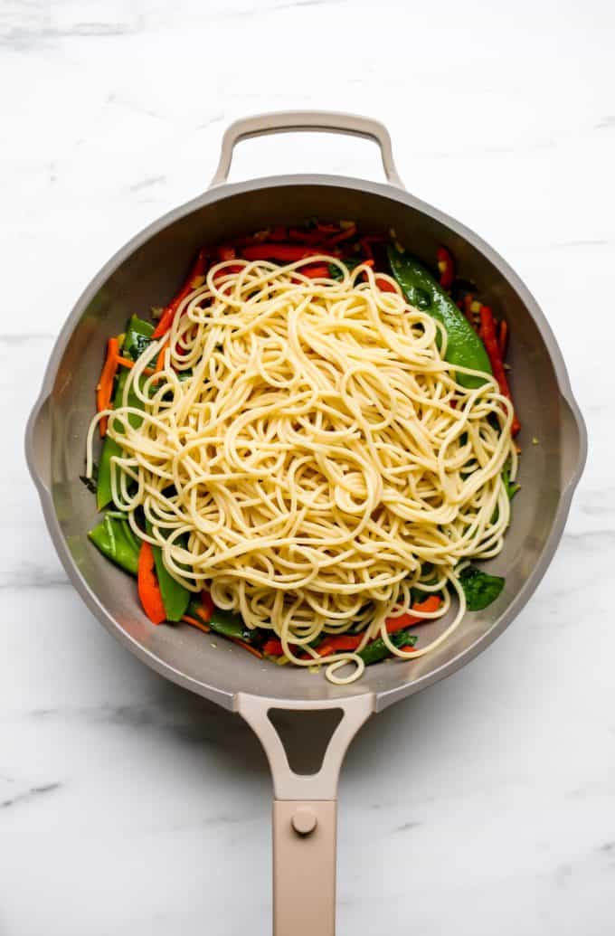 A pan with noodles and vegetables in it