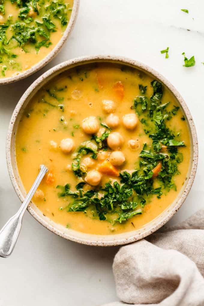 Chickpea soup in a bowl topped with parsley