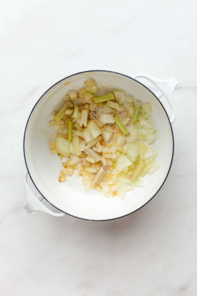 onions and lemongrass in a white pot