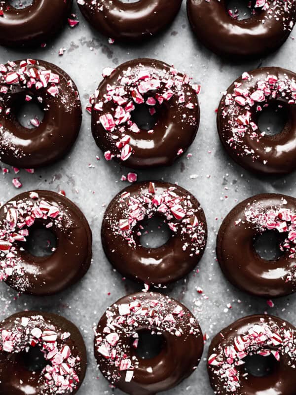 Mocha donuts with chocolate glaze and crushed candy canes on them