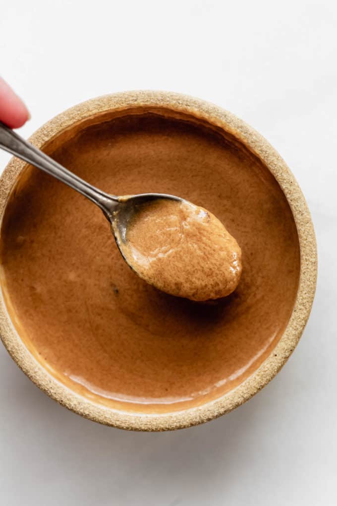 A spoon of Thai peanut sauce