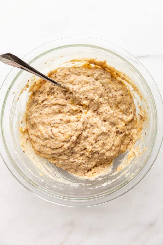 vegan banana bread batter in a clear mixing bowl